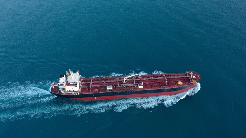 A petroleum tanker underway open sea. Supertanker loaded with full of oil, ploughs through the water. Aerial tracking shot of a 182 meters long oil chemical tanker ship
 Royalty-Free Stock Footage #1080081323