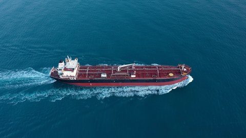 A petroleum tanker underway open sea. Supertanker loaded with full of oil, ploughs through the water. Aerial tracking shot of a 182 meters long oil chemical tanker ship
