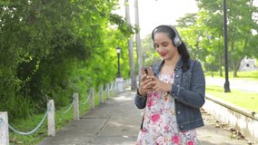 An HD video of a Hispanic girl with a smartphone jamming to music in her wireless headset in Panama