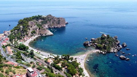 Isola Bella small island near Taormina, Sicily, southern Italy. Narrow path connects Isola Bella island to mainland Taormina beach surrounded by azure waters of the Ionian Sea.