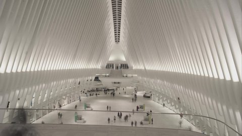 Commuters walk  in The Oculus Futuristic Westfield Shopping Center at World Trade Center Manhattan, New York,circa 2019, time lapse