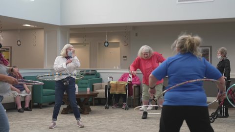 Indianapolis, IN USA - September 18 2021: This video shows a group of senior citizens hula hooping in a retirement home.