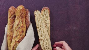 Time lapse. Flat lay. Freshly baked small French baguette bread.
