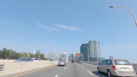 Toronto, Ontario, Canada September 2021Driving plate POV highway into Toronto city skyline office buildings and condos
