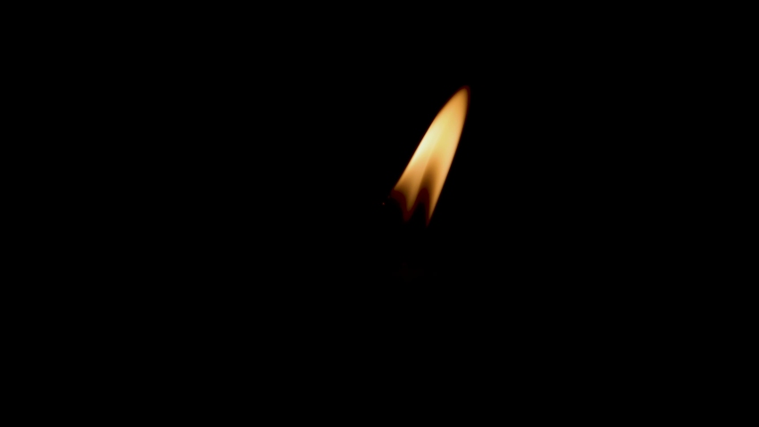Close-up of the flame burning on the candle with isolated on a black background. Candle flame in the dark. flame on a black background.
 | Shutterstock HD Video #1080101633