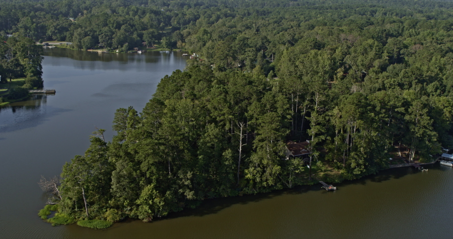 Jackson Georgia Aerial v4 drone flying along shimmering high falls lake toward downstream towaliga river, surrounded by evergreen forest - Shot with Inspire 2, X7 camera - September 2020