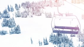 Animation of glowing spots of light over ski lift and winter countryside scenery. christmas, winter, tradition and celebration concept digitally generated video.