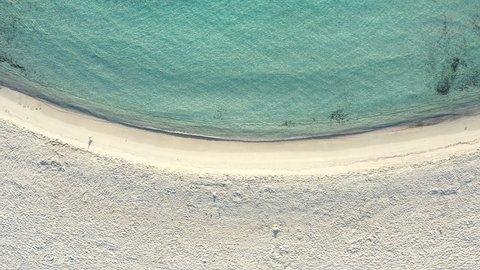 View from above, stunning aerial view of a white sand beach bathed by a turquoise, crystal clear water. Prince Beach (Spiaggia del Principe) Sardinia, Italy.
