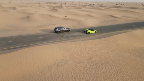 expensive and luxurious cars drive along the road. Lamborghini and Rolls Royce. Dubai UAE, 2021.08.15