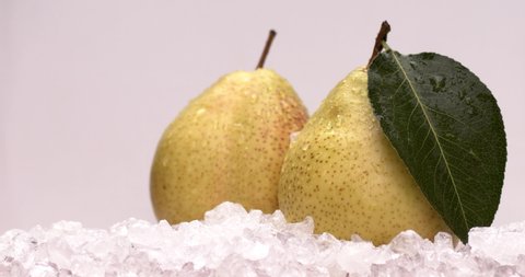 Yellow fresh pear cold ice with fresh and yummy pears, natural and organic fruits in white background. Filmed high speed cinema camera, slow motion footage, 8K downscale, 4K.