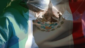 Animation of flag of mexico over surgeons in operating theatre. global medicine, healthcare services during covid 19 pandemic concept digitally generated video.