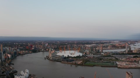 Aerial view of Millennium Dome on Greenwich Peninsula. The O2 entertaining district on Thames riverbank in sunset time. London, UK