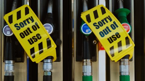 LONDON, circa 2021 - Petrol nozzles are covered with a sign at a filling station as the fuel supply crisis continues in the UK owing to the shortage of tanker drivers and the extended impact of BREXIT