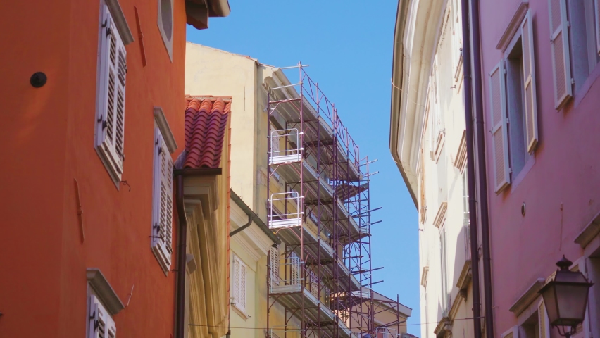 Historical building with scaffolding in narrow town street