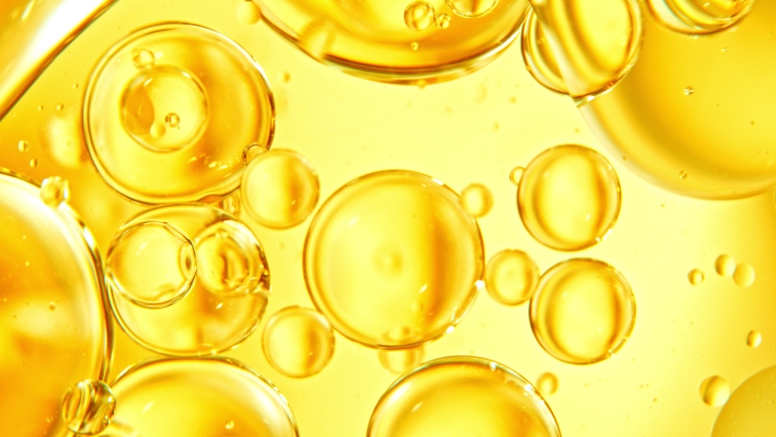 Super Slow Motion Shot of Moving Oil Bubbles on Golden Background at 1000fps. Royalty-Free Stock Footage #1080133172