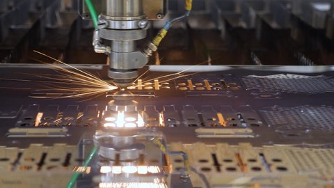 Automated machine CNC laser cutting metal plate. Modern machine laser metal sheet cnc cutting steel plate. High precision cutting machine metal part. Burn laser cutter work steel products. Metalwork