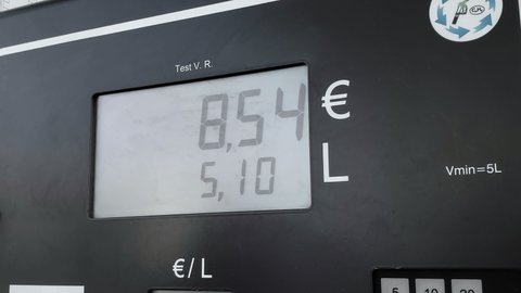 Gas station fuel meter counter close up while refueling a car,increasing petrol costs