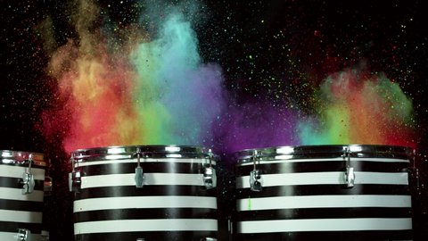 Super slow motion of  drummer banging on drums with colored powder explosion. Filmed on high speed cinema camera, 1000 fps. Speed ramp effect.