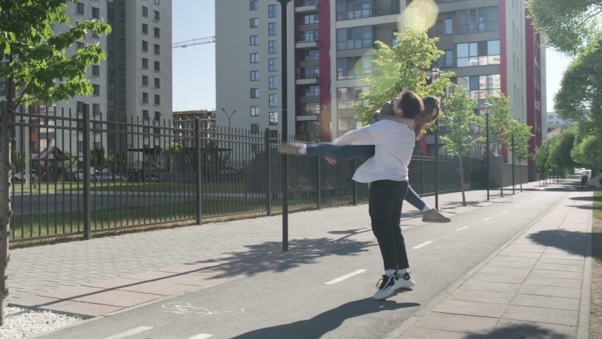 Street dance. Young couple dancing in the street. The guy and the girl move rhythmically. They dance and smile. In a new area. Stylish guy and girl.