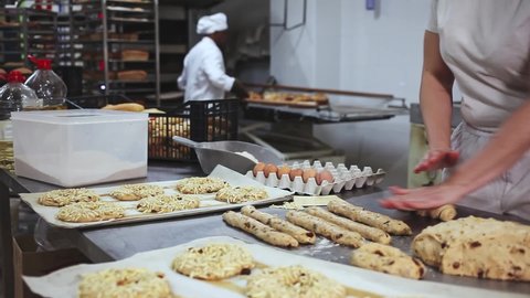 hands of chef kneading dough in bakery 