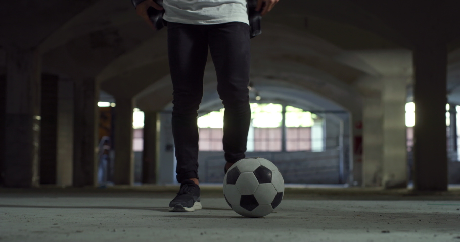 Low Angle, Ground Level Shot: Focus on the Legs of a Talented Young Soccer Athlete Juggling a Ball Skilfully. Man Showing His Freestyle Football Skills in an Underground Parking Lot, Doing Tricks Royalty-Free Stock Footage #1080161312