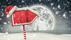 Snow falling and santa hat over red wooden sign post on winter landscape against moon in night sky. christmas festivity and celebration concept - Powered by Shutterstock - Get 15% off with code: PIKWIZARD15