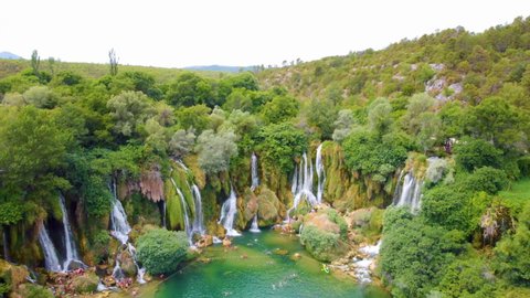 Locals And Tourists Enjoying Kravica Waterfall With Green Nature Landscape In Bosnia and Herzegovina. - aerial pullback