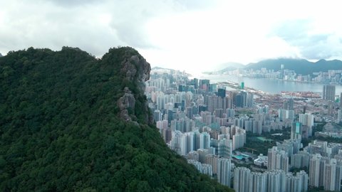 Drone flyover of iconic Lion Rock, Cinematic aerial shot of an endless mountain and forest landscape in Hong Kong.