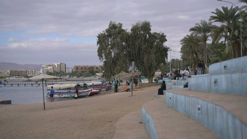 AQABA, JORDAN - 28TH DECEMBER 2018: Local people on the beach in the Aqaba, Jordan, Asia.