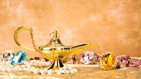 The formation of a magical deity from a gold, magic lamp surrounded by a wealth of jewelry and fantasy.
