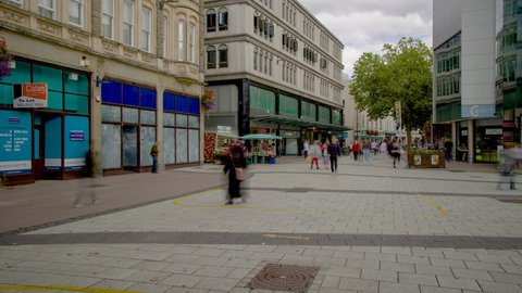 CARDIFF, UNITED KINGDOM - SEPTEMBER 24 2021: Timelapse of crowds of people shopping in Queen Street - the main shopping area in the Welsh capital city, Cardiff