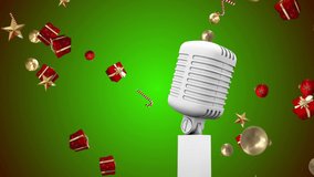 Animation of vintage microphone with christmas presents falling on green background. christmas, winter, tradition and celebration concept digitally generated video.