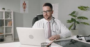 Doctor having an online appointment with a patient. Healthcare professional doing a video chat, remotely consulting a patient - online doctor, health and saftey 4k footage