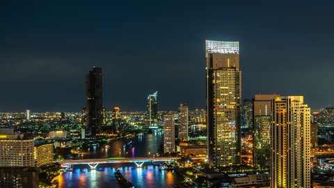 Time lapse night cityscape and high-rise buildings in metropolis city center . Downtown business district in panoramic view .
