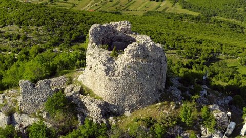 Remains Of Cacvina Castle In The Mountain On A Sunny Day Near Trilj, Croatia. - aerial orbit