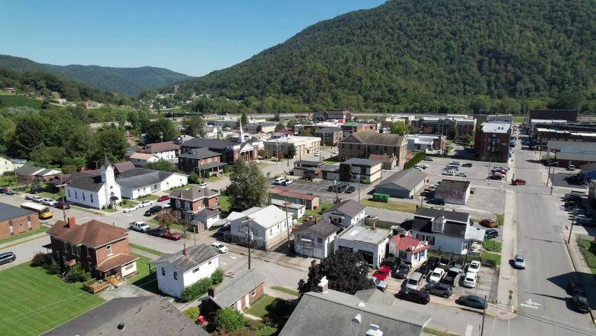 aerial push into pineville kentucky with church in foreground, small town america, hometown, small town usa, middle america in the suburbs