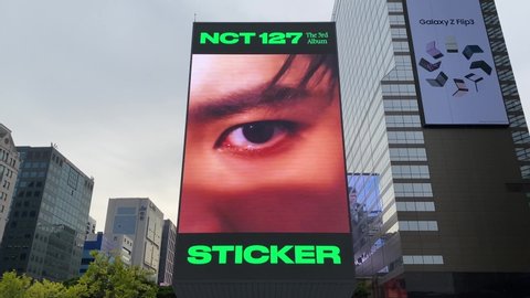 Seoul, South Korea - October 3 2021:  K-pop Artist NCT 127 Sticker ad is playing on digital billboard at Samseong-dong.