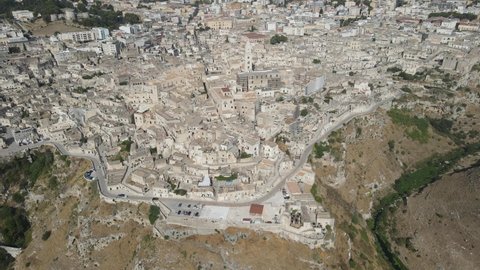 Aerial view of medieval city of Matera (Sassi di Matera) in beautiful golden morning light at sunrise. Birds view of Sassi di Matera, in Basilicata, southern Italy, and is an Unesco world heritage.