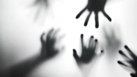Silhouette of a zombie hand on white background
