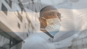 Animation of flag of argentina waving over man wearing face mask during covid 19 pandemic. global covid 19 pandemic concept digitally generated video.