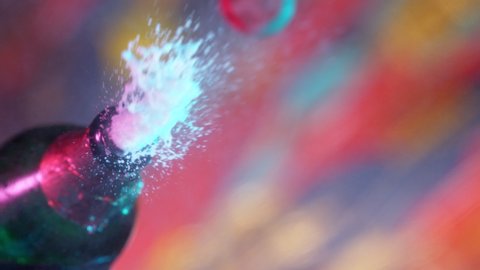 Super slow motion of Champagne explosion illuminated by neon lights. Filmed on high speed cinema camera, 1000fps