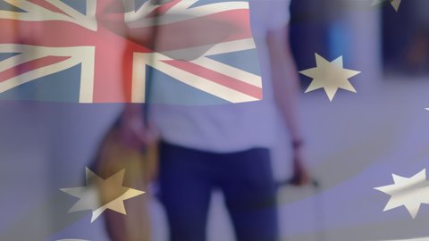 Animation of flag of australia waving over man wearing face mask during covid 19 pandemic. global covid 19 pandemic concept digitally generated video.