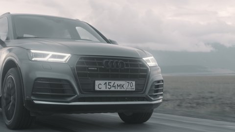 ALTAI, RUSSIA - 29 JUNE 2021: Audi Q5 drives down the highway. FRONT Close Up