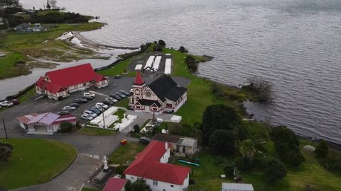 Historic Anglican Church in Ohinemutu, Rotorua - aerial orbit reveal heritage site in New Zealand