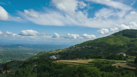Clouds moving fast over Caramulo mount and valley in background, Portugal. Timelapse