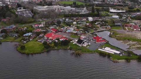 Ohinemutu Maori Village aerial birds eye view of Meeting building, War Memorial, School, Square and housing area in Rotorua, New Zealand