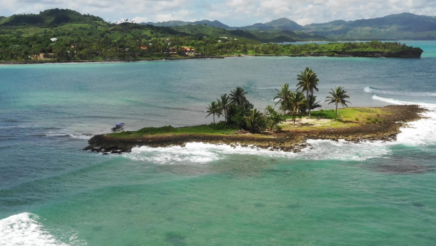Small island near Las Galeras beach, Samana Peninsula. Aerial circling