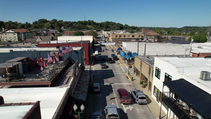 aerial push in through american flags over corbin kentucky in 4k