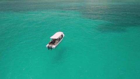 AERIAL - Tour boat lying in the beautiful turquoise waters off of Cancun, Mexico