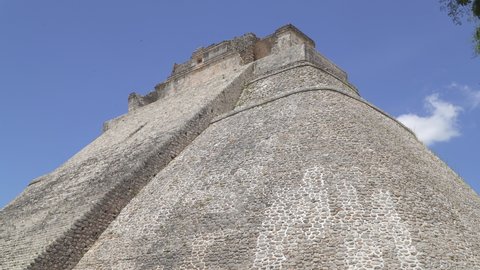 UXMAL, YUCATAN, MEXICO - MAY 2021: Ruins of Piramide del adivino (Pyramid of the Magician), the most recognizable landmark of ancient Mayan city of Uxmal, Yucatan